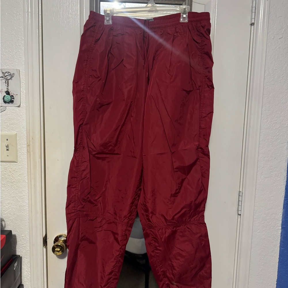 Men's red Nike track pants and windbreaker